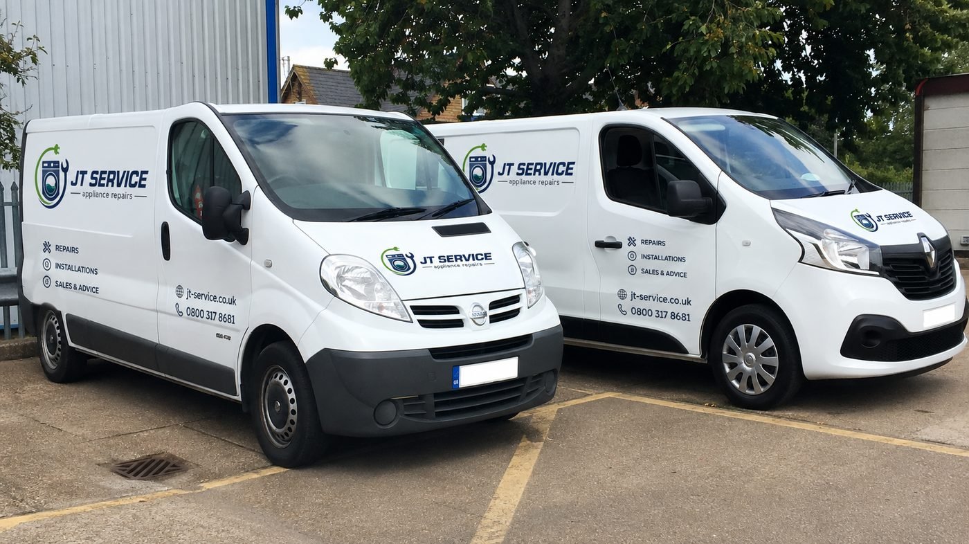 Two branded JT Service appliance repair vans
